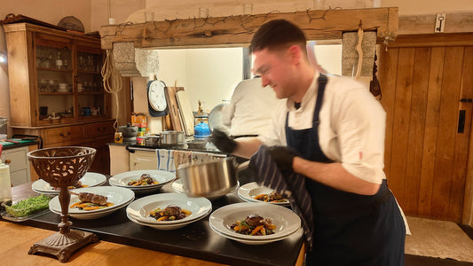 Paul putting together a main course of duck leg